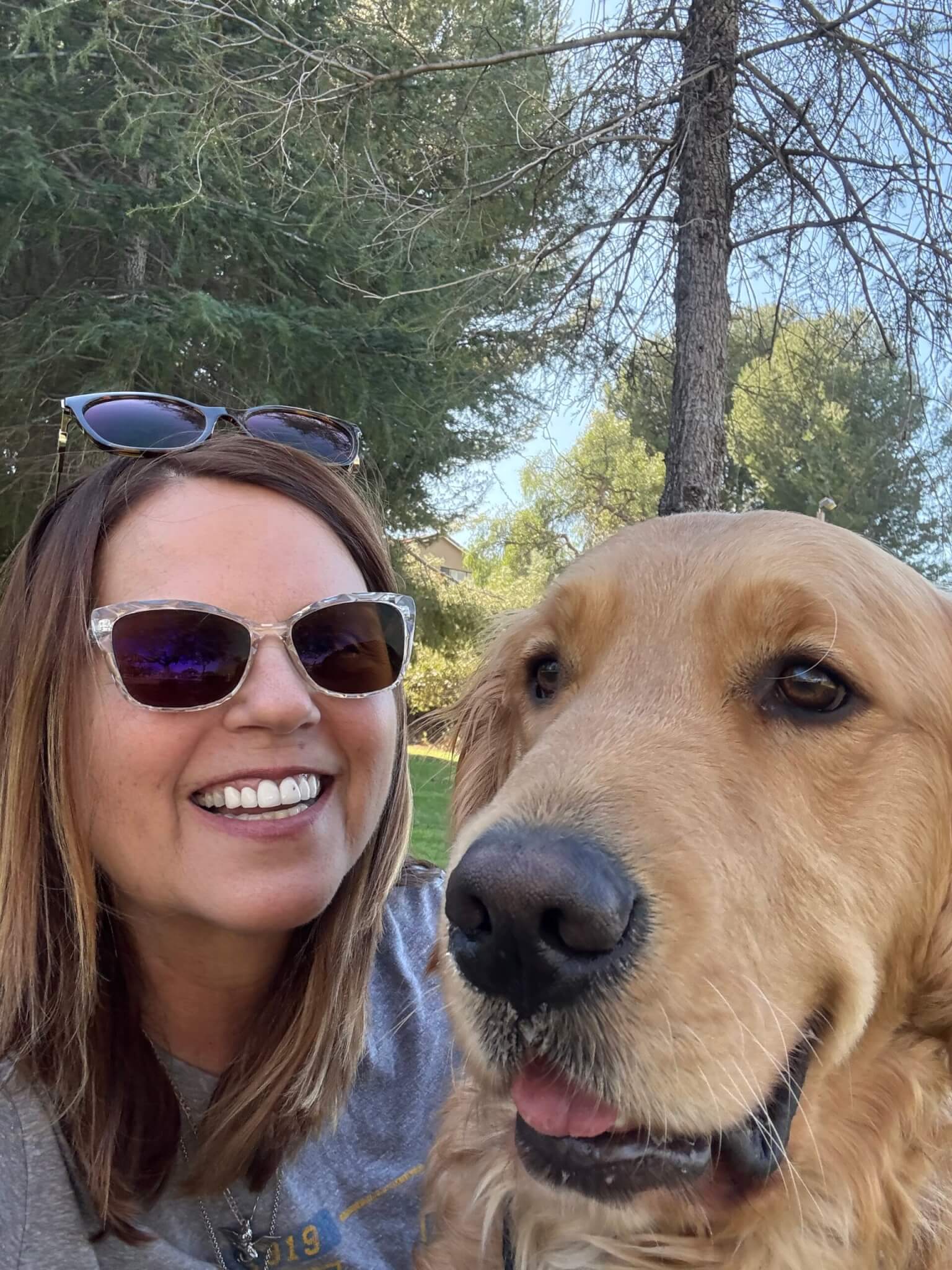 A selfie of Lara and Mushu both smiling outside.
