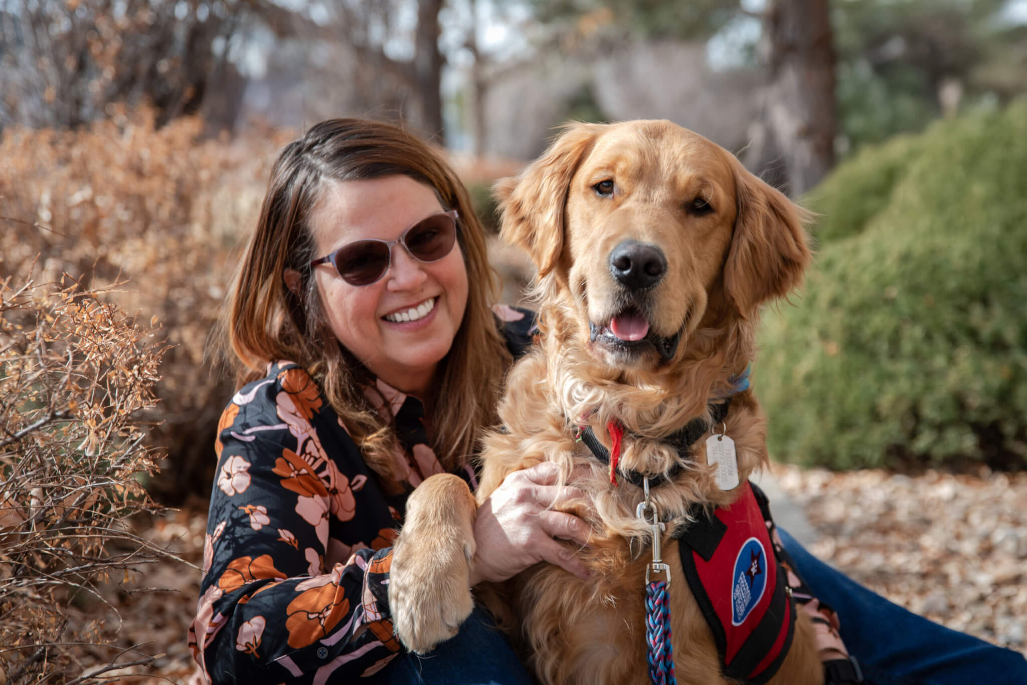 Lara and her service dog golden retriever Mushu.
