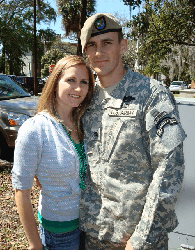 Nick wearing his U.S. Army uniform standing beside his wife.