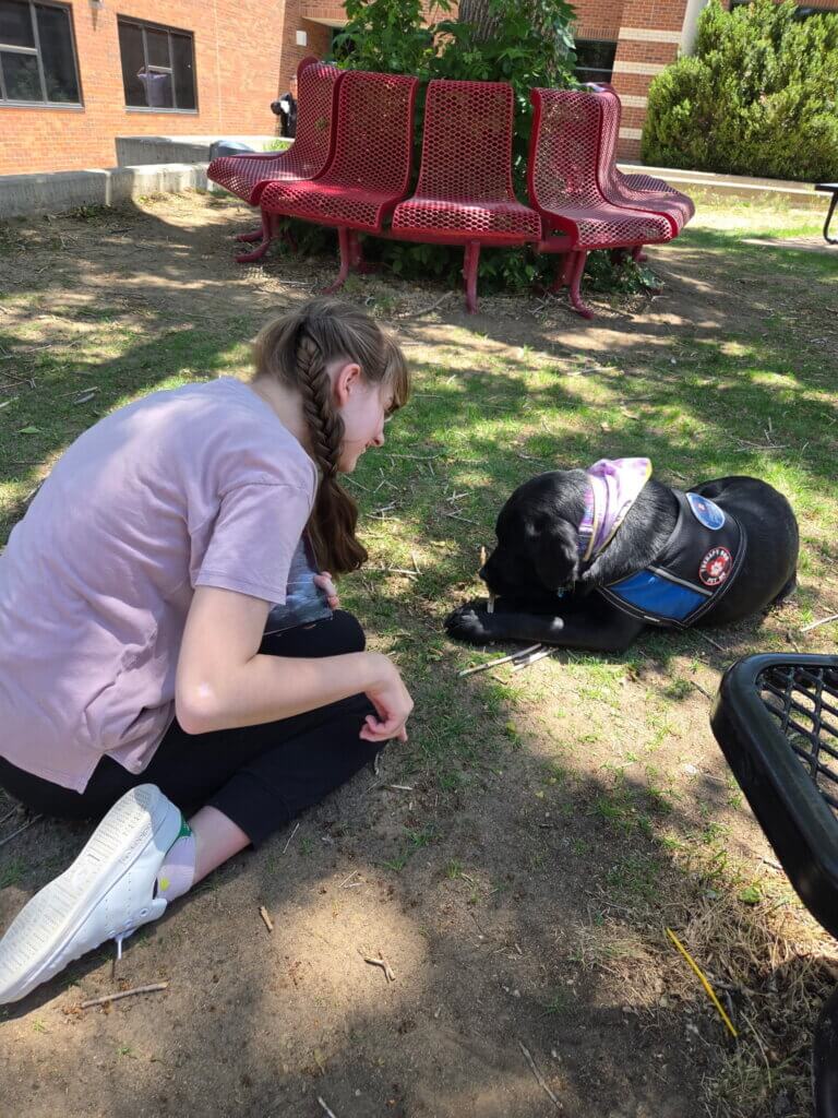 Facility dog with students with disabilities.